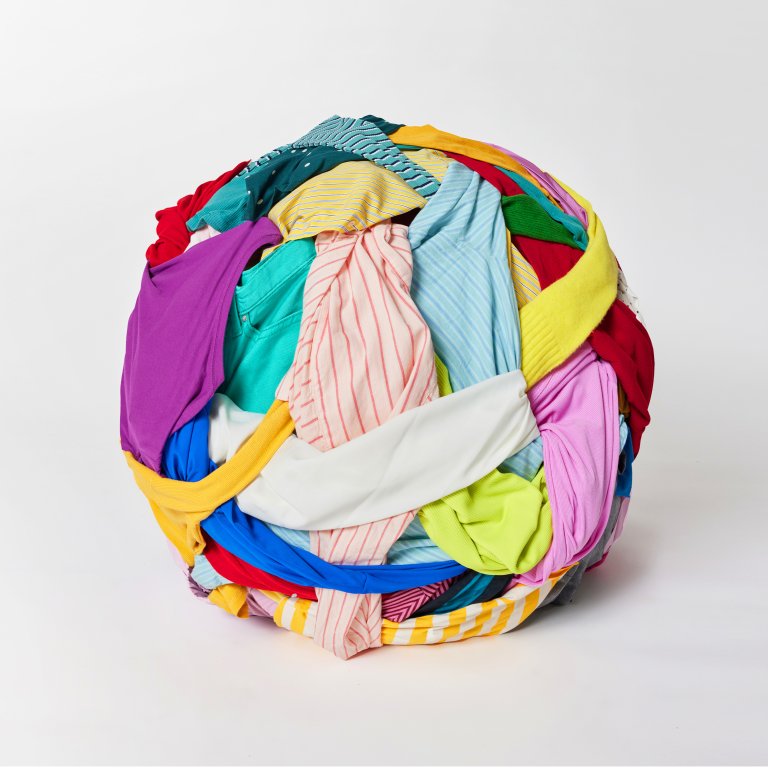 Image of a ball of polyester clothing waiting to be recycled