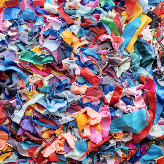 Image of scraps of polyester textile waiting to be recycled